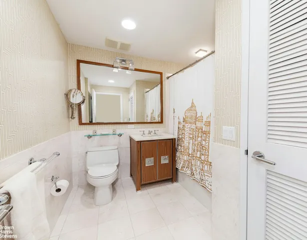 a bathroom with a toilet sink and mirror