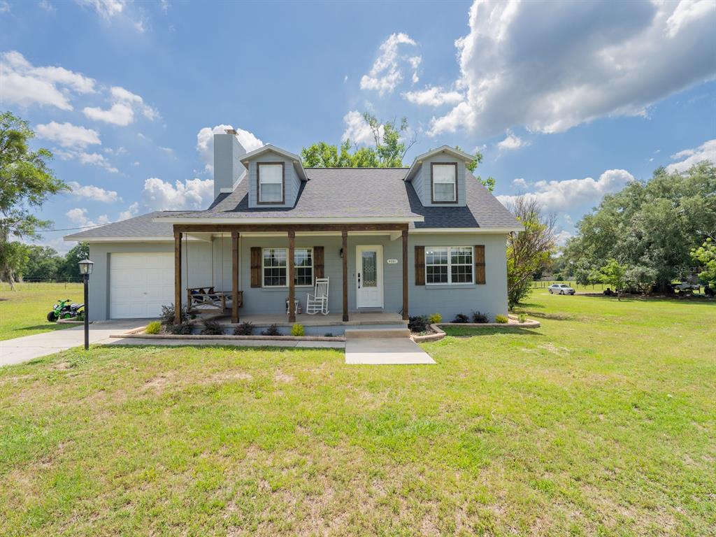 4381 Northeast 105th Place Anthony, FL 32617 - Photo 5 of 49 a front view of a house with swimming pool having outdoor seating
