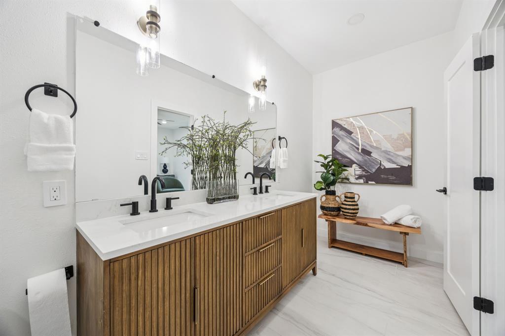 2516 Sunridge Road Carrollton, TX 75006 - Photo 14 of 39 a en suite bathroom with a double vanity sink a mirror and a