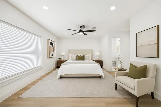 a bedroom with a bed couch and window