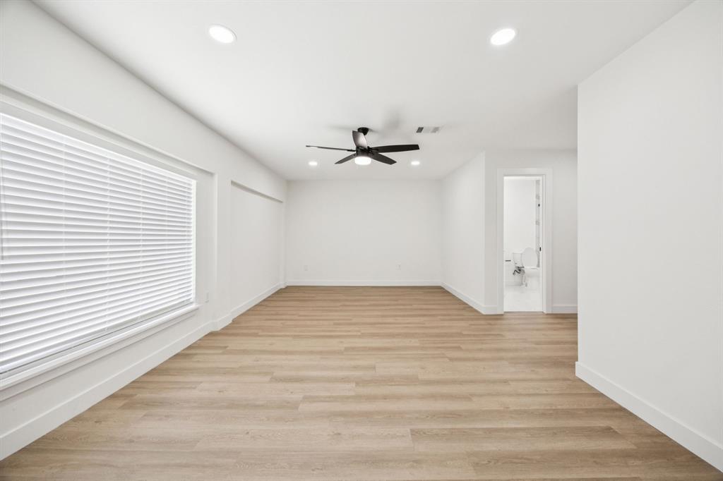2516 Sunridge Road Carrollton, TX 75006 - Photo 17 of 39 wooden floor in an empty room with a window