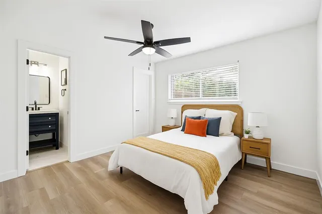 a bedroom with a bed and a ceiling fan