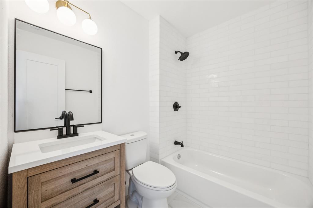 2516 Sunridge Road Carrollton, TX 75006 - Photo 27 of 39 a bathroom with a sink a toilet and shower