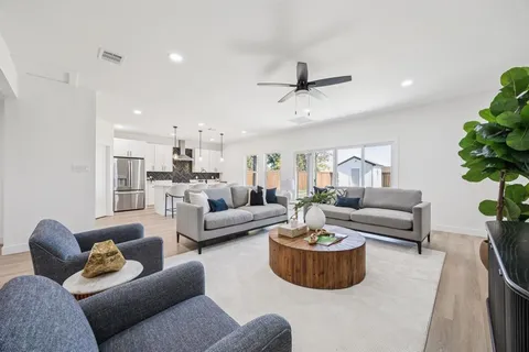 a living room with furniture a rug and a chandelier
