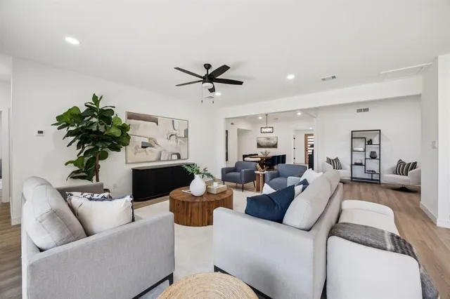 a living room with furniture a chandelier and a fireplace
