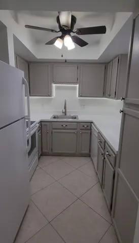 a kitchen with a sink a stove and a refrigerator