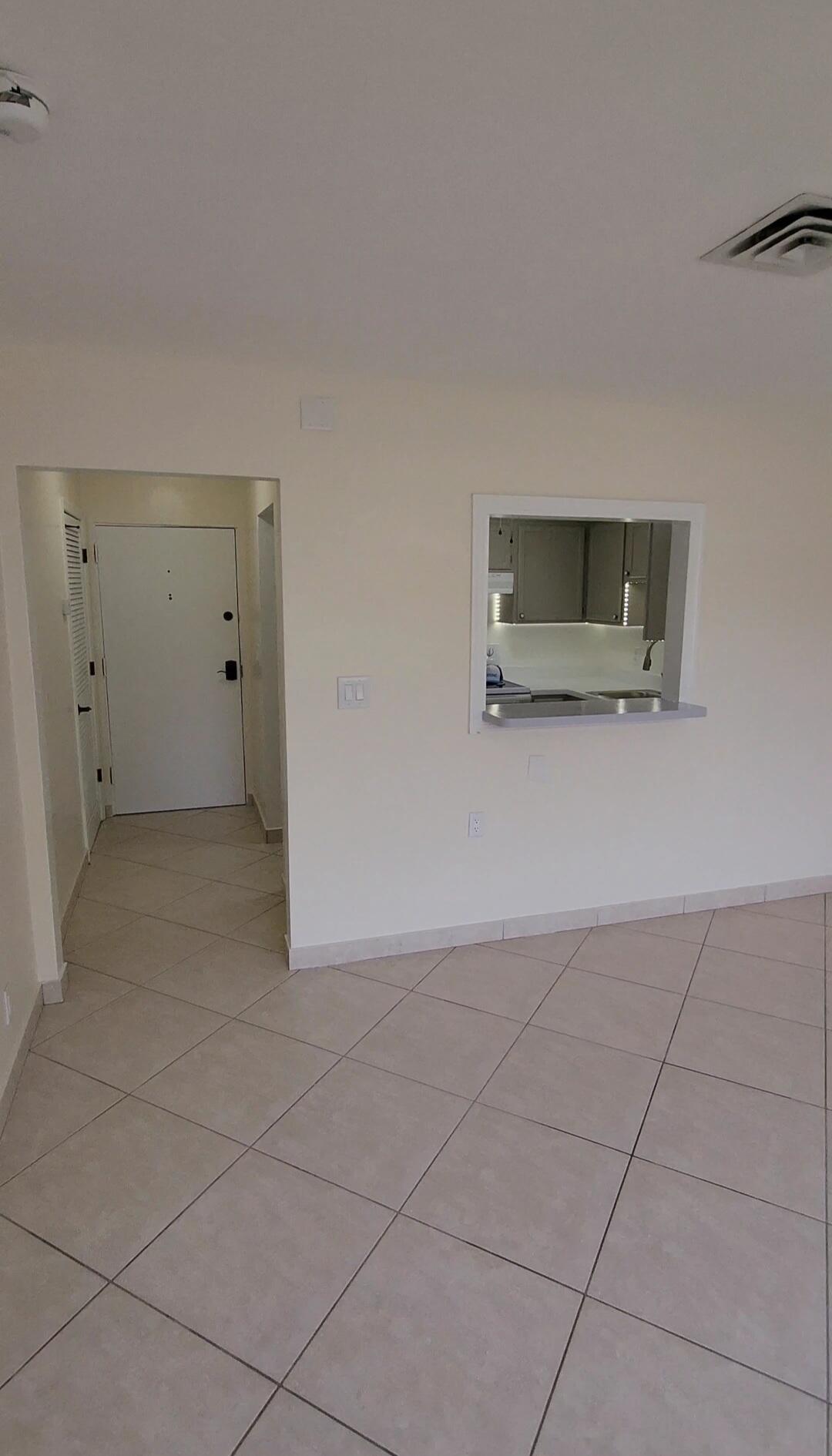 105 South Riverside Drive, Unit 302 Pompano Beach, FL 33062 - Photo 17 of 37 a living room with stainless steel appliances kitchen island granite countertop a rug and white cabinets
