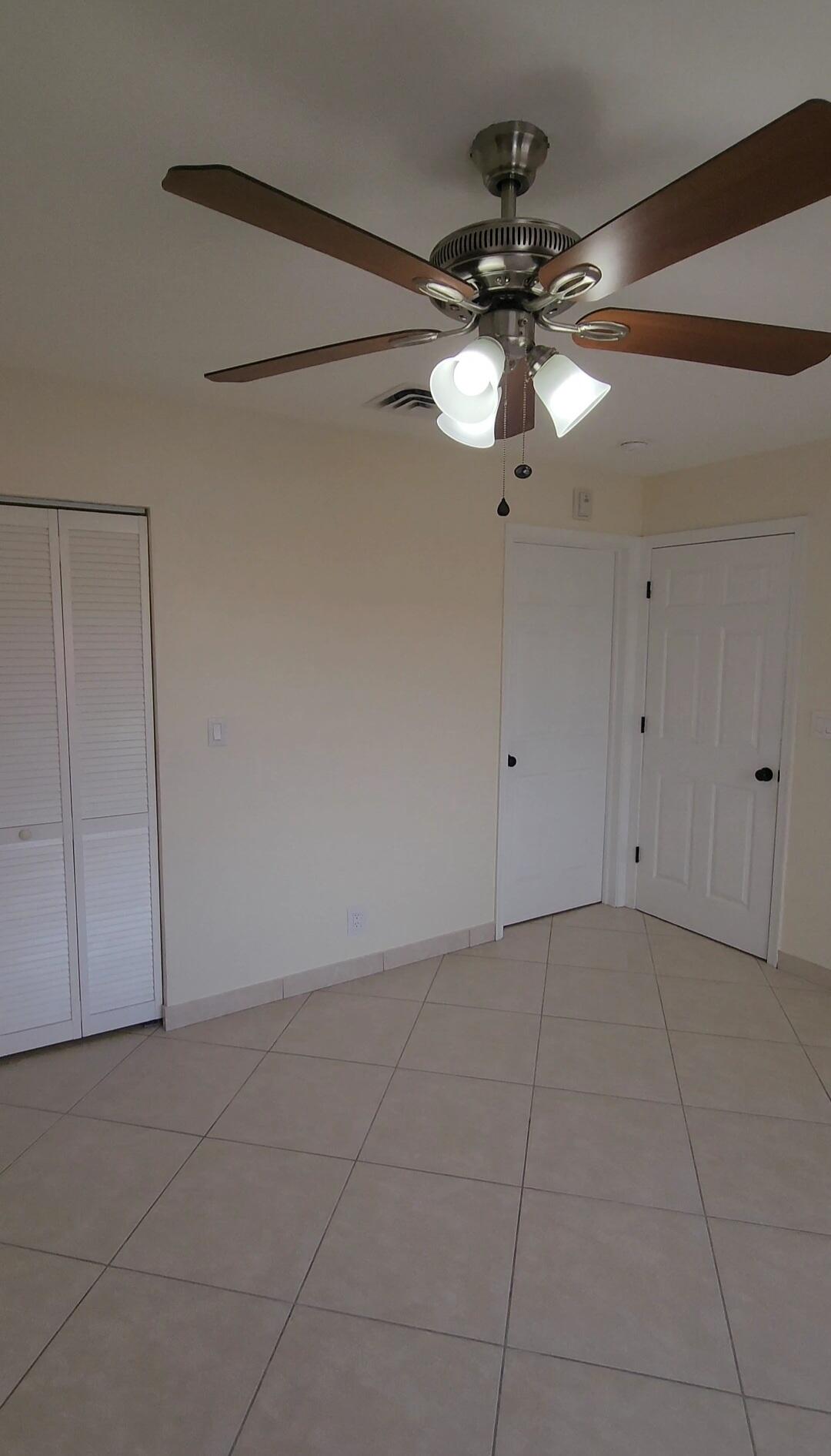 105 South Riverside Drive, Unit 302 Pompano Beach, FL 33062 - Photo 20 of 37 a view of a chandelier fan and closet in a room