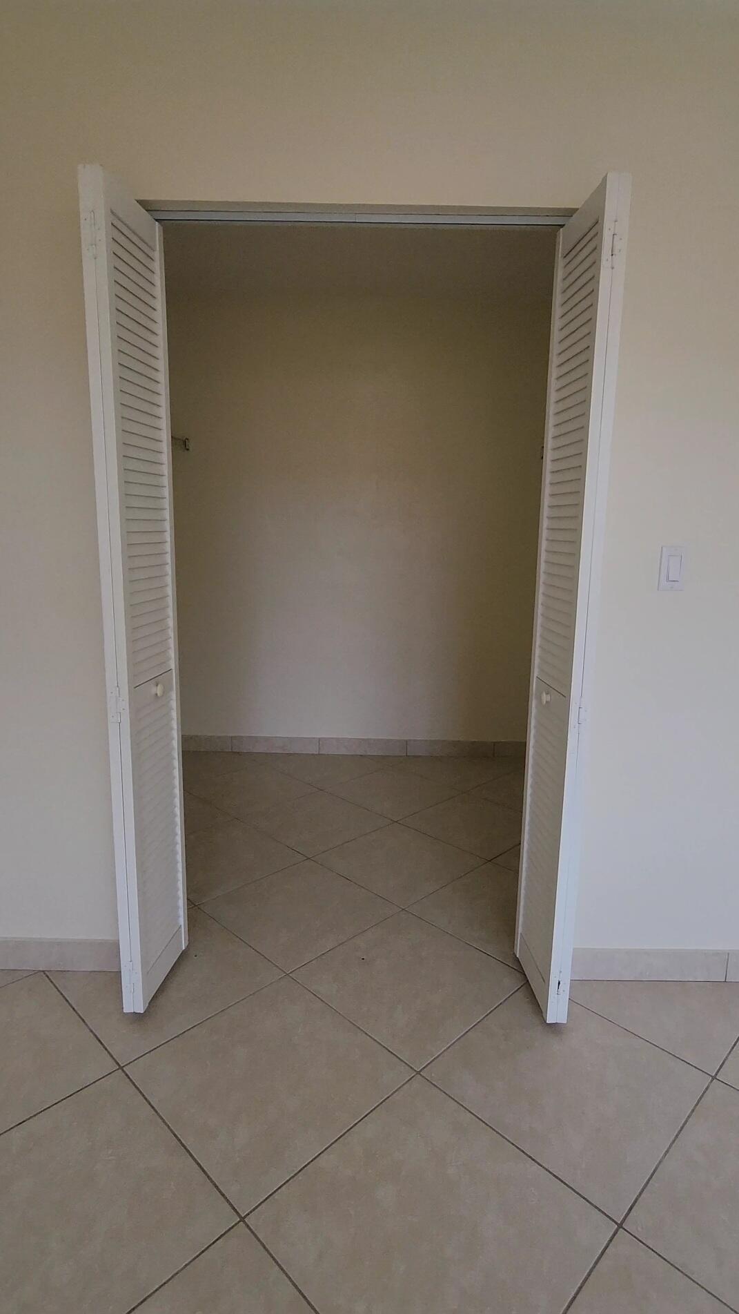 105 South Riverside Drive, Unit 302 Pompano Beach, FL 33062 - Photo 23 of 37 an empty room with a bench