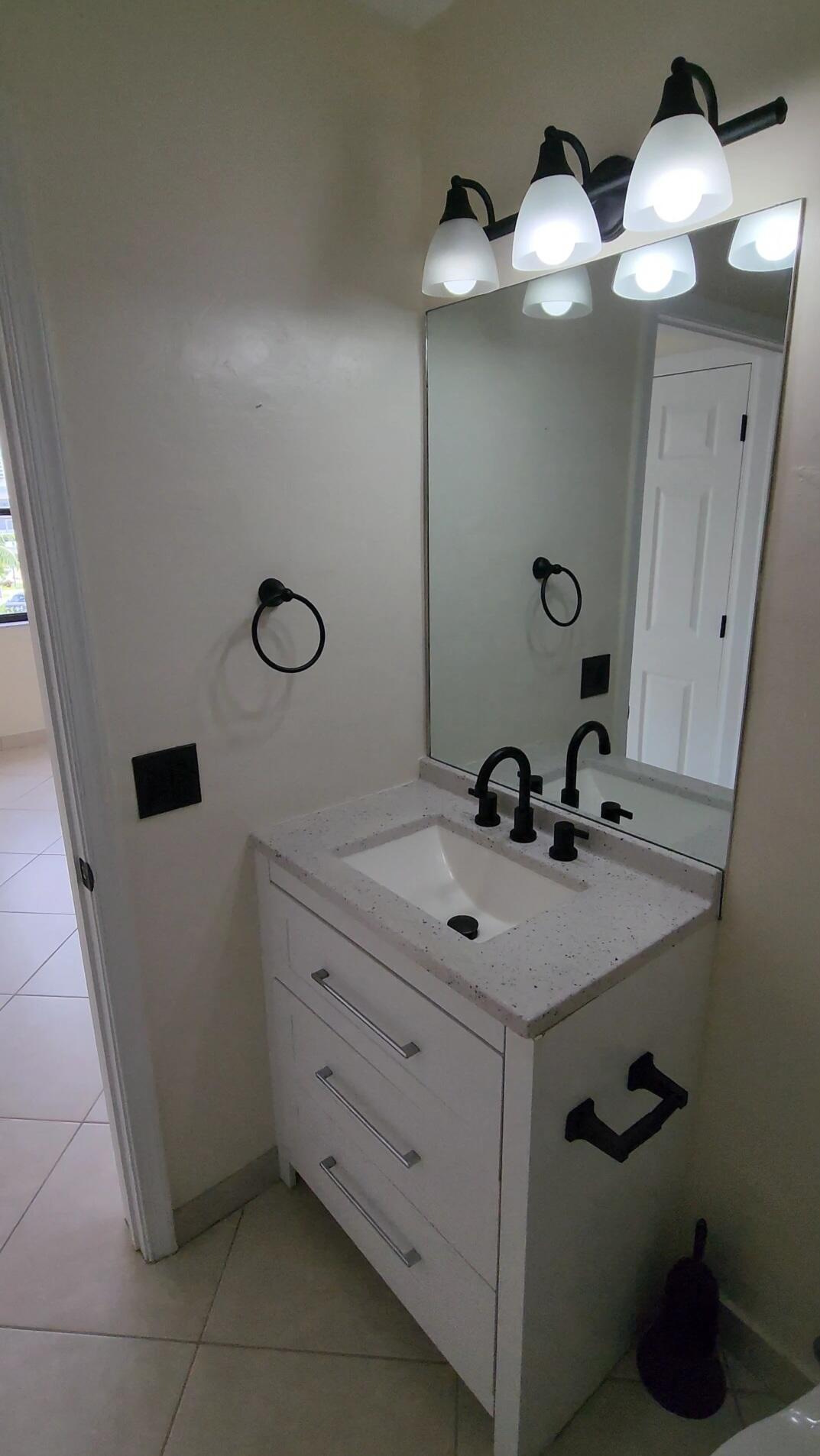 105 South Riverside Drive, Unit 302 Pompano Beach, FL 33062 - Photo 26 of 37 a bathroom with a sink and a mirror