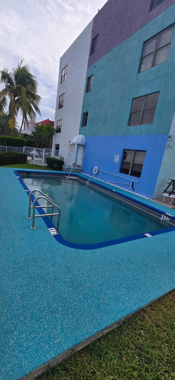 105 South Riverside Drive, Unit 302 Pompano Beach, FL 33062 - Photo 29 of 37 a view of a swimming pool with a yard