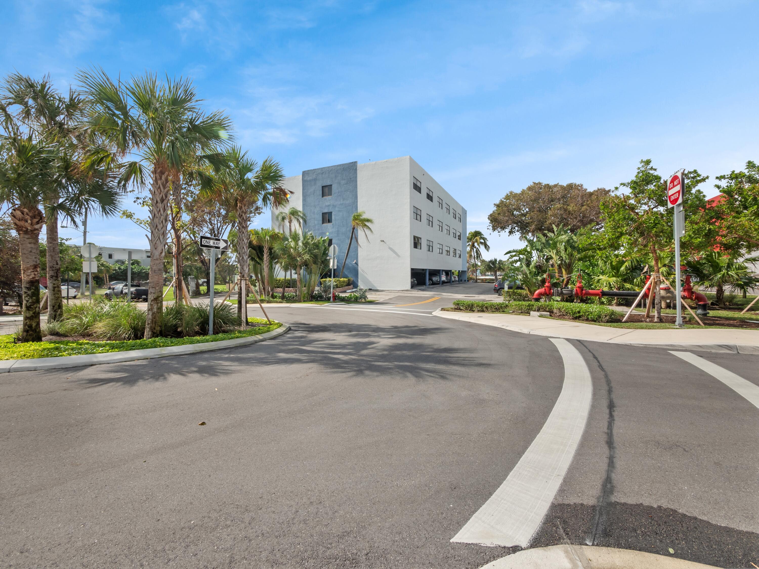 105 South Riverside Drive, Unit 302 Pompano Beach, FL 33062 - Photo 3 of 37 a front view of a house with a yard and a garage