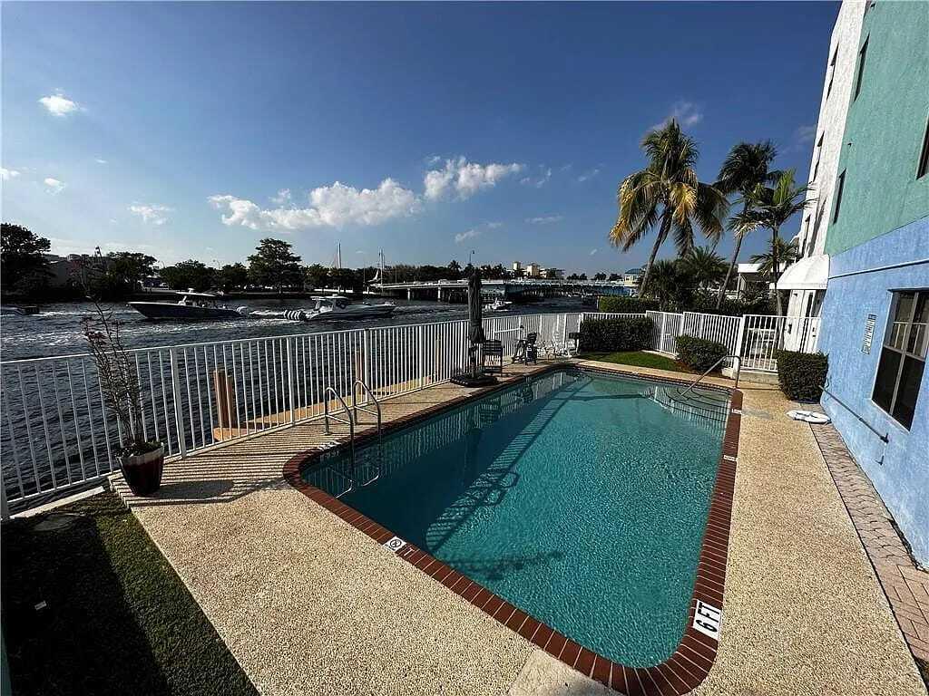 105 South Riverside Drive, Unit 302 Pompano Beach, FL 33062 - Photo 31 of 37 a view of a swimming pool with a lake view