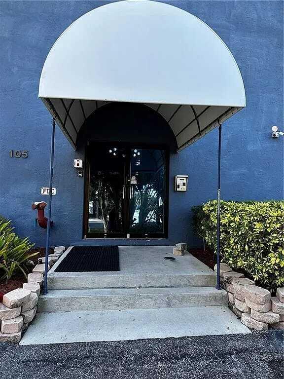 105 South Riverside Drive, Unit 302 Pompano Beach, FL 33062 - Photo 6 of 37 a living room with a couch and potted plant