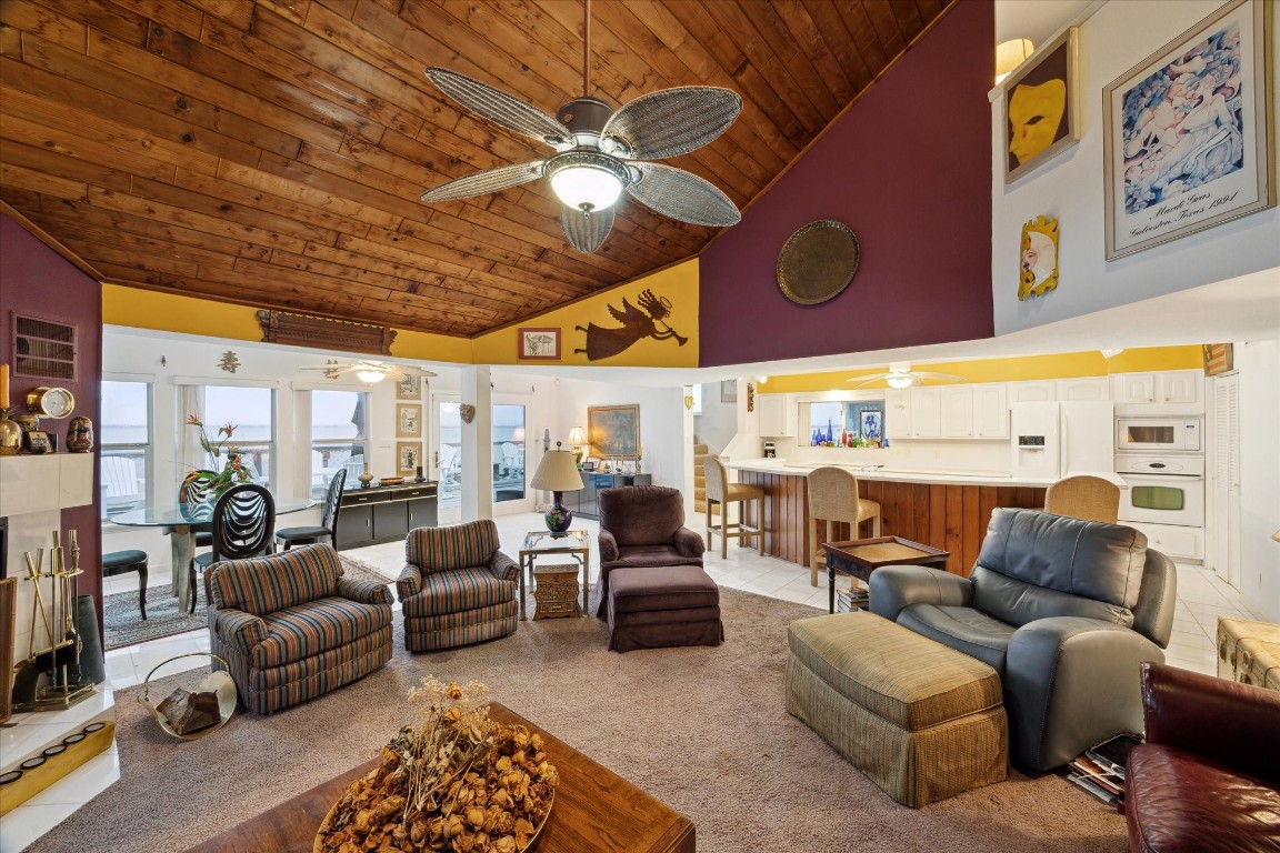 251 Isles End Road Tiki Island, TX 77554 - Photo 7 of 23 family room looking towards the kitchen and back stair case to primary