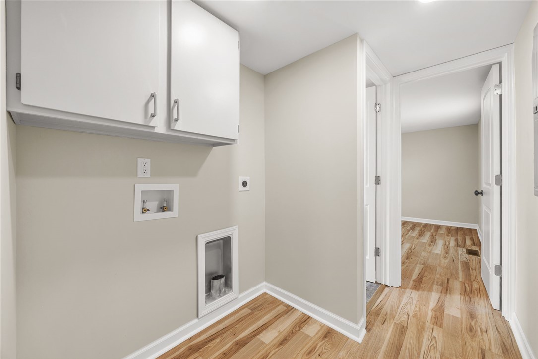 139 Davis Road Easley, SC 29640 - Photo 18 of 34 This laundry area features convenient hookups and overhead cabinetry, ensuring functionality.