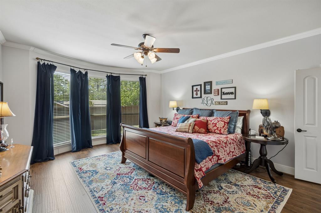 8104 Red Riv Run North Richland Hills, TX 76180 - Photo 14 of 38 a bedroom with a bed wooden floor and a table