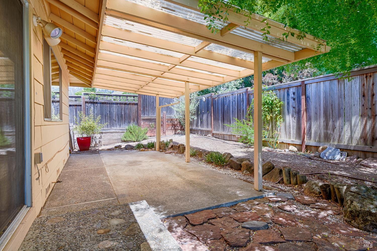 138 Oak Shadow Drive Santa Rosa, CA 95409 - Photo 42 of 50 a view of a backyard with table and chairs under an umbrella