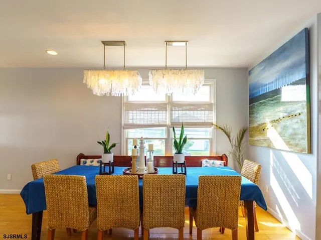 a view of a dining room with furniture and a window
