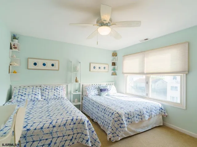 a view of a dining room with furniture and a chandelier
