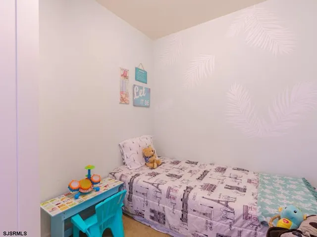 a bathroom with a granite countertop sink a mirror and a shower