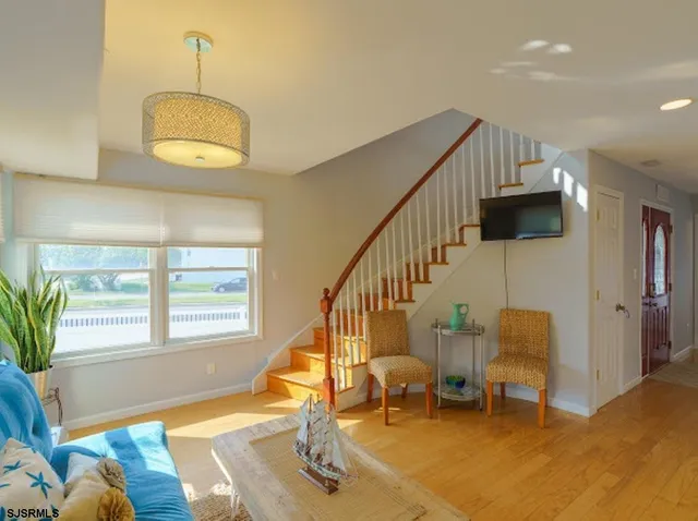 a view of a livingroom with furniture staircase and a dining room