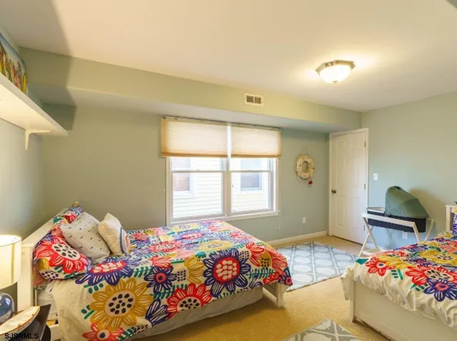 a bedroom with bed and a window