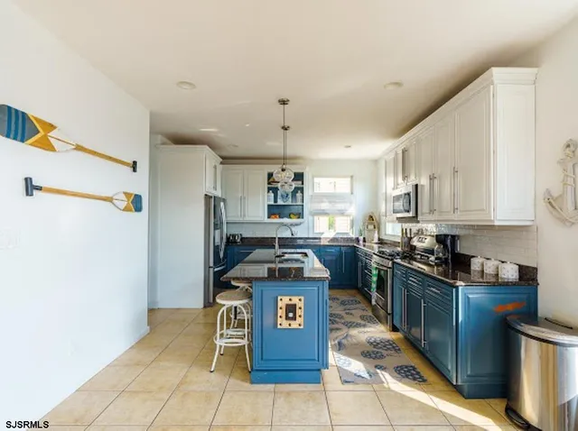 a kitchen with stainless steel appliances granite countertop a stove and a refrigerator