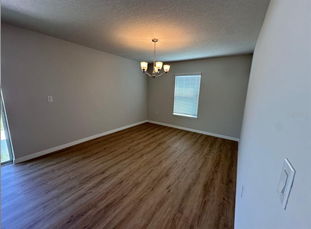 2467 Zuyder Terrace North Port, FL 34286 - Photo 12 of 14 a view of an empty room with wooden floor and a window