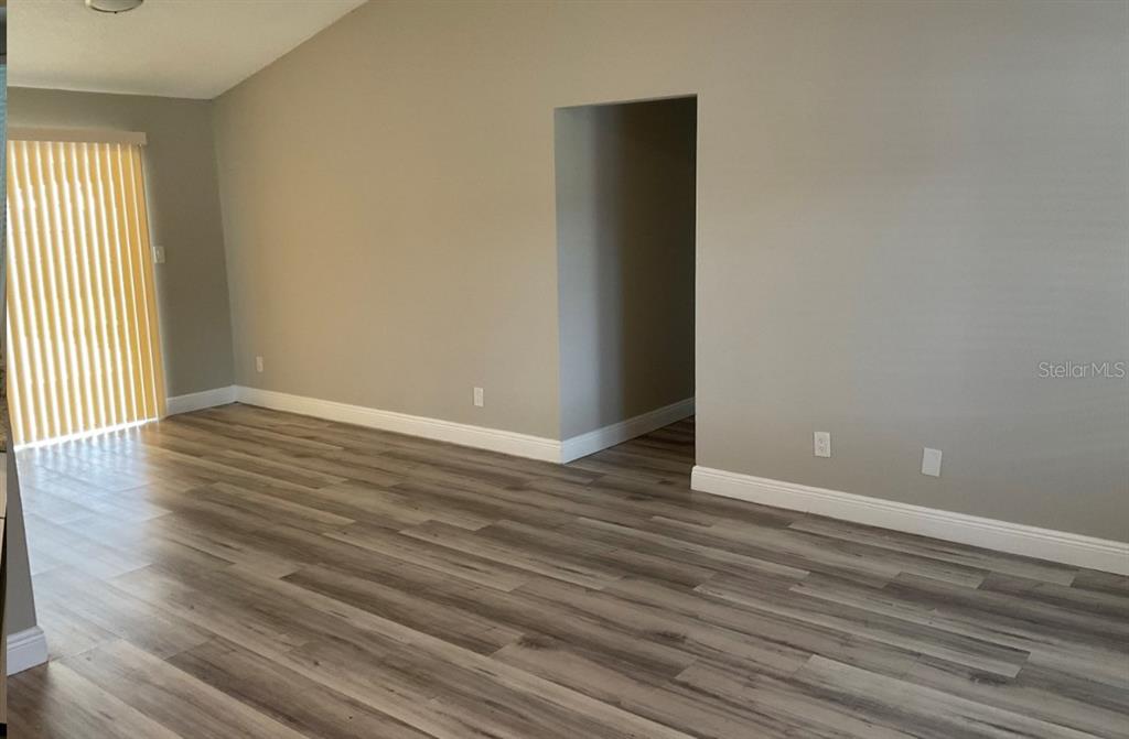 2467 Zuyder Terrace North Port, FL 34286 - Photo 7 of 14 a view of an empty room with wooden floor and a window