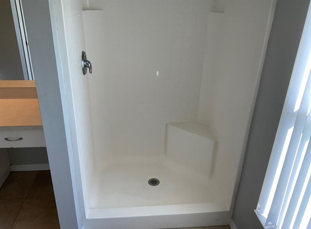 2467 Zuyder Terrace North Port, FL 34286 - Photo 9 of 14 a bathroom with a glass door