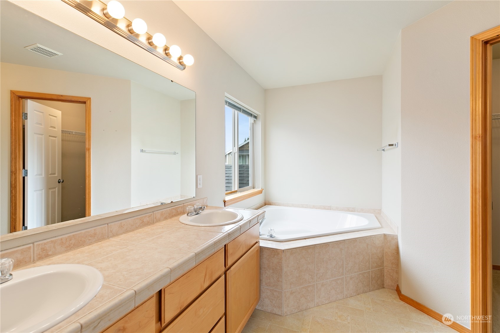 5209 Northeast 5th Court Renton, WA 98059 - Photo 14 of 28 a bathroom with a granite countertop sink and a bathtub