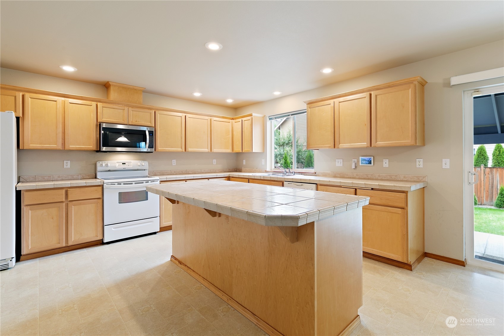 5209 Northeast 5th Court Renton, WA 98059 - Photo 7 of 28 a kitchen with stainless steel appliances granite countertop a stove a sink and a microwave