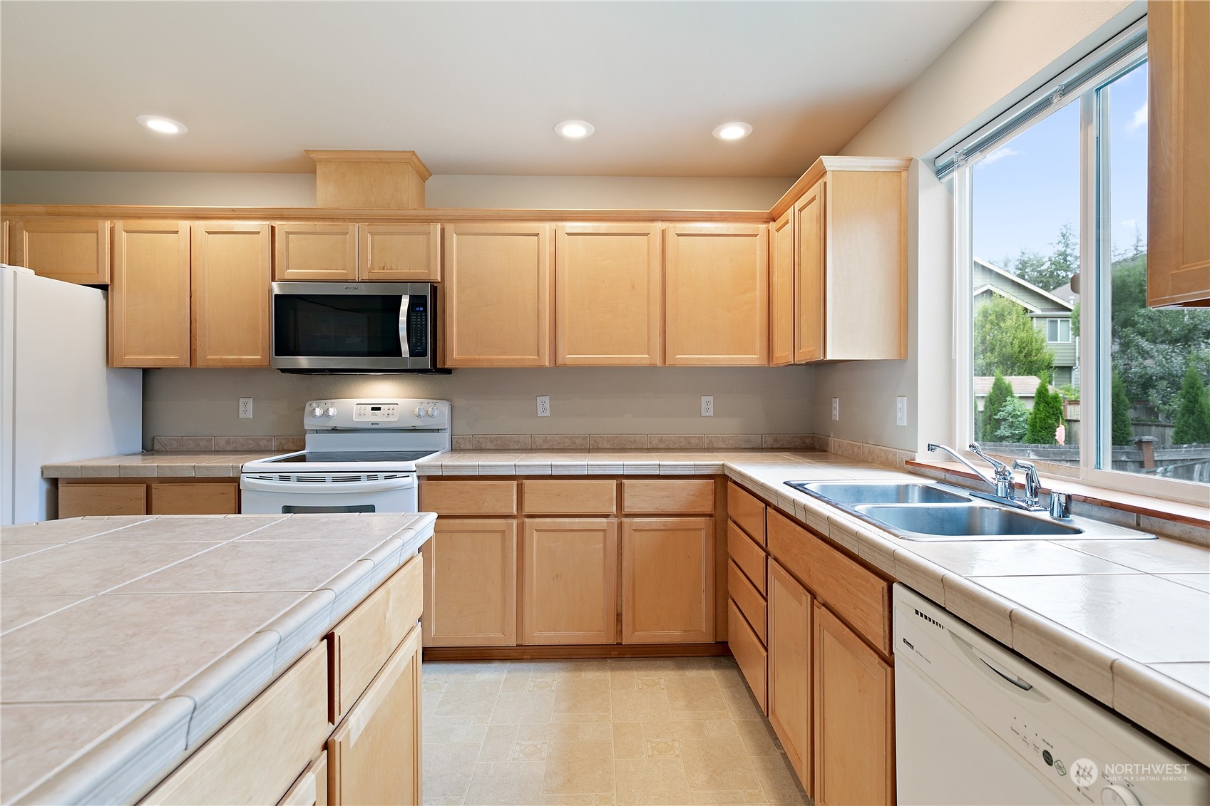 5209 Northeast 5th Court Renton, WA 98059 - Photo 8 of 28 a kitchen that has a sink and a stove in it