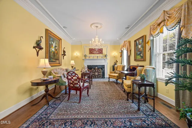 a view of a dining room with furniture a chandelier and wooden floor