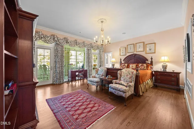 a bedroom with a bed and a lamp on dresser
