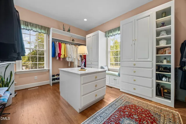 a living room with furniture a chandelier and a wooden floor