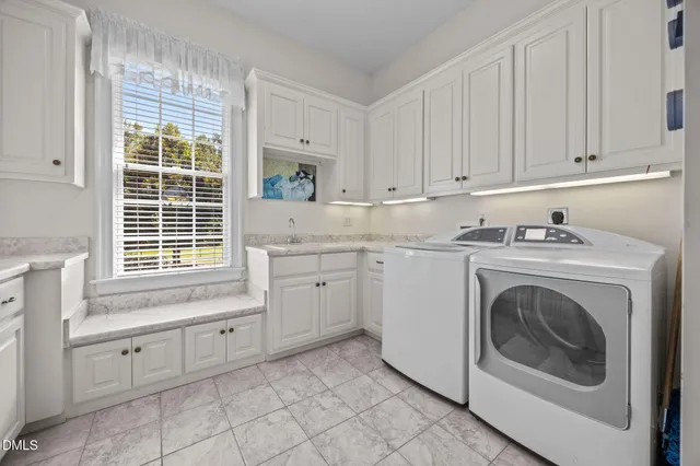 a view of a swimming pool with a table and chairs under an umbrella