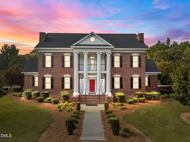 a view of a dining room with furniture a chandelier and wooden floor