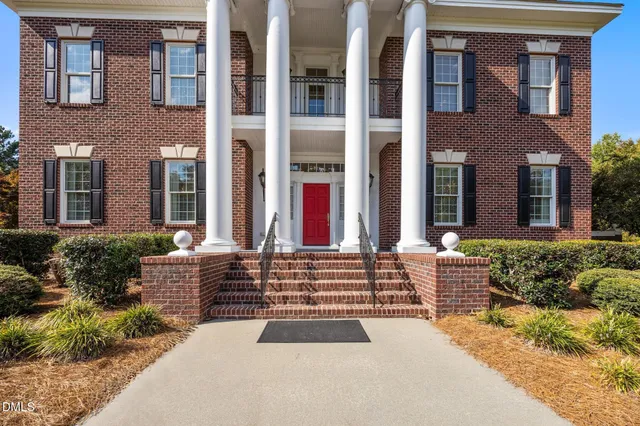 a living room with furniture a fireplace and a table