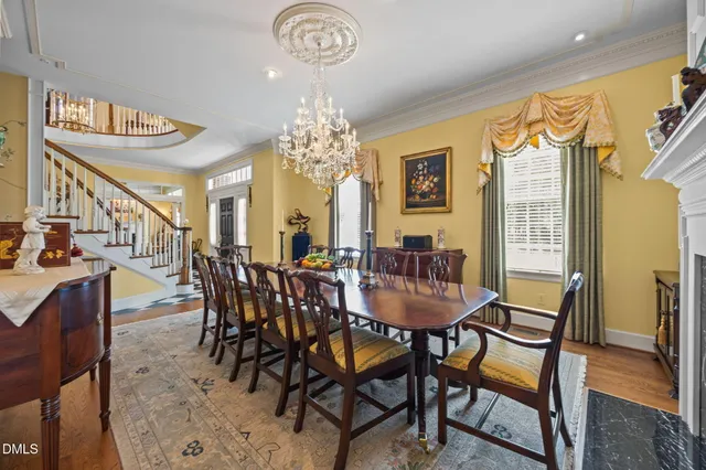 a kitchen with stainless steel appliances granite countertop a refrigerator a sink dishwasher a stove and white countertops with wooden floor