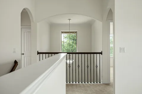 a view of a hallway with windows