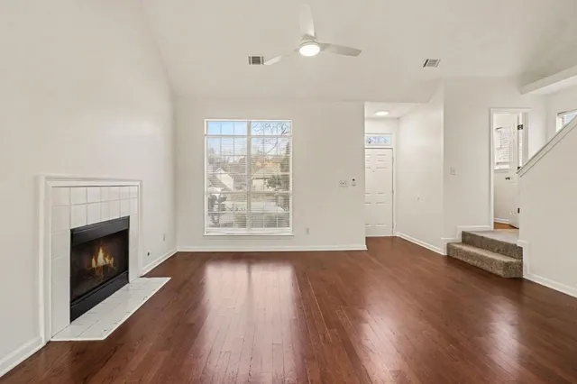 wooden floor fireplace and natural light in room