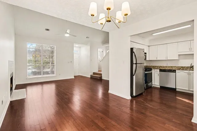a view of kitchen with refrigerator microwave and wooden floor
