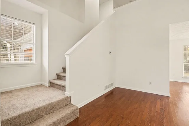 a view of an empty room and wooden floor