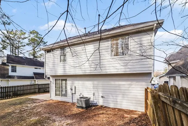 a view of a house with backyard and sitting area