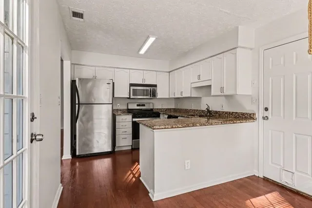 a kitchen with wooden cabinets and stainless steel appliances