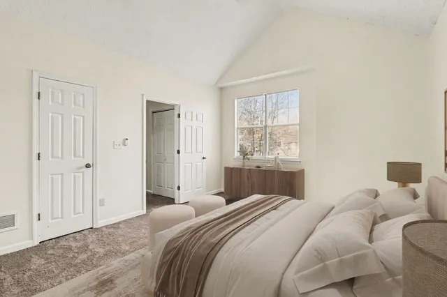 a bedroom with a bed and a window