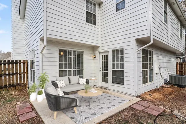 a view of a patio with couches table and chairs and wooden floor