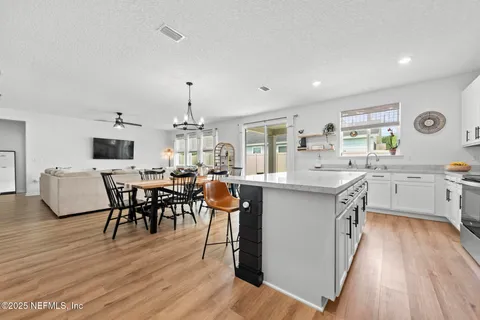 a kitchen with stainless steel appliances granite countertop a stove and a sink